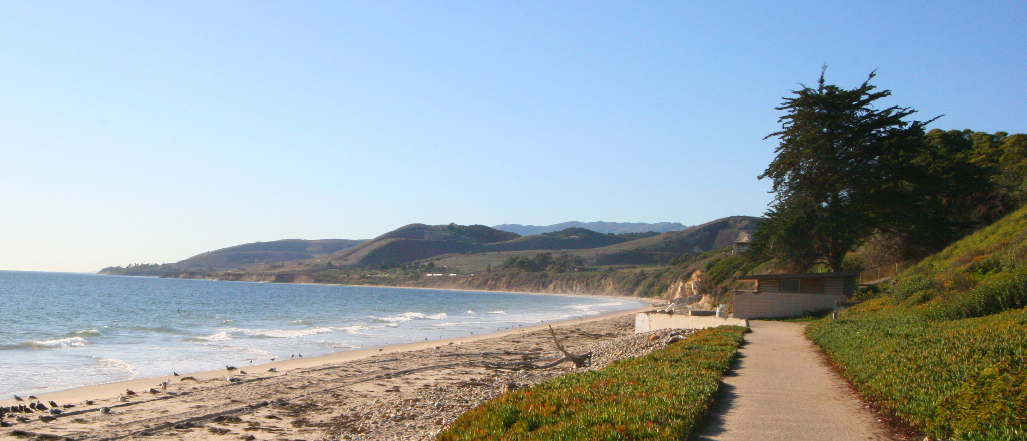 The sandy shoreline, coastal bluffs, and Pacific Ocean at El Capitán State Beach near Santa Barbara.